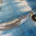 Silver feather necklace with antique coin
