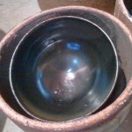 ame yu bowl saggar fired with charcoal. too bad this one tipped into the wall and melted on. had to break off some of the lip to remove it. will post a finished picture of this one after it is repaired.