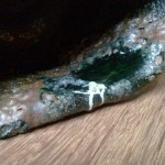 lip detail. the ash dripped here in a dark green pool. I don't know what the little white wormlike things are. some look like they dripped from above. Maybe excess silica from the straw rope?