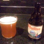A glass full of beer, cloudy from the residual yeast.