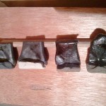 the 4 test tiles, 2 in white clay, 2 in red. Far right was quenched in water, far left was buried in rice hulls, middle two air cooled.